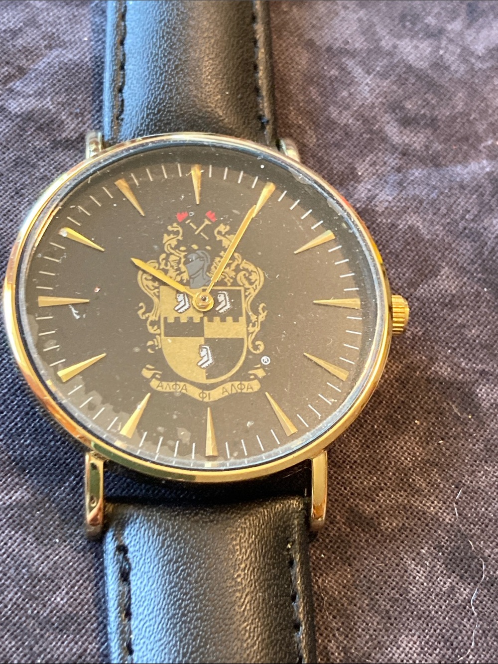 Men's Black and Gold Crest Dial Dress Watch keeps perfect time